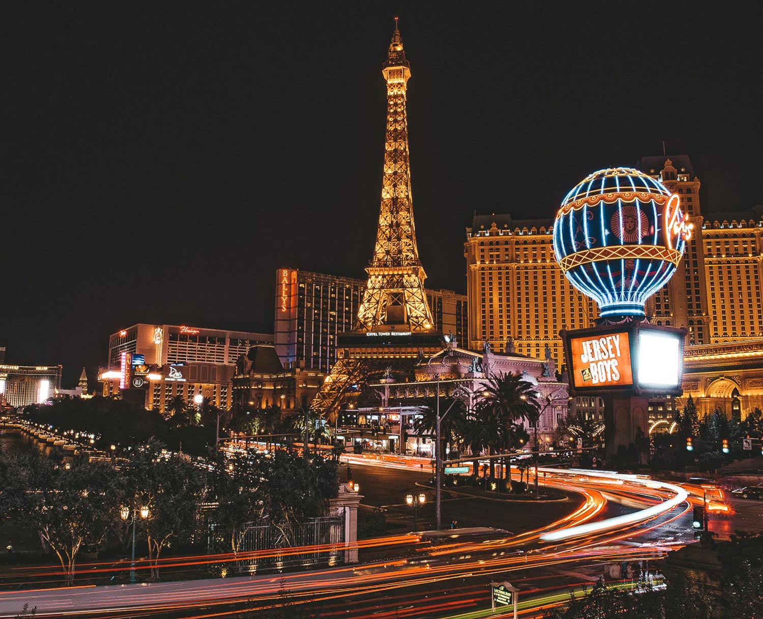 Beautiful lady watching the famous hotel in Las Vegas, standing in the busy  city. Famous tourist Stock Photo by travnikovstudio