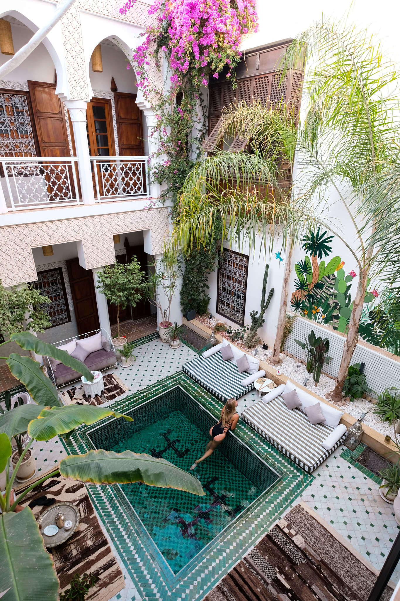 blonde in pool at riad yasmin in morocco