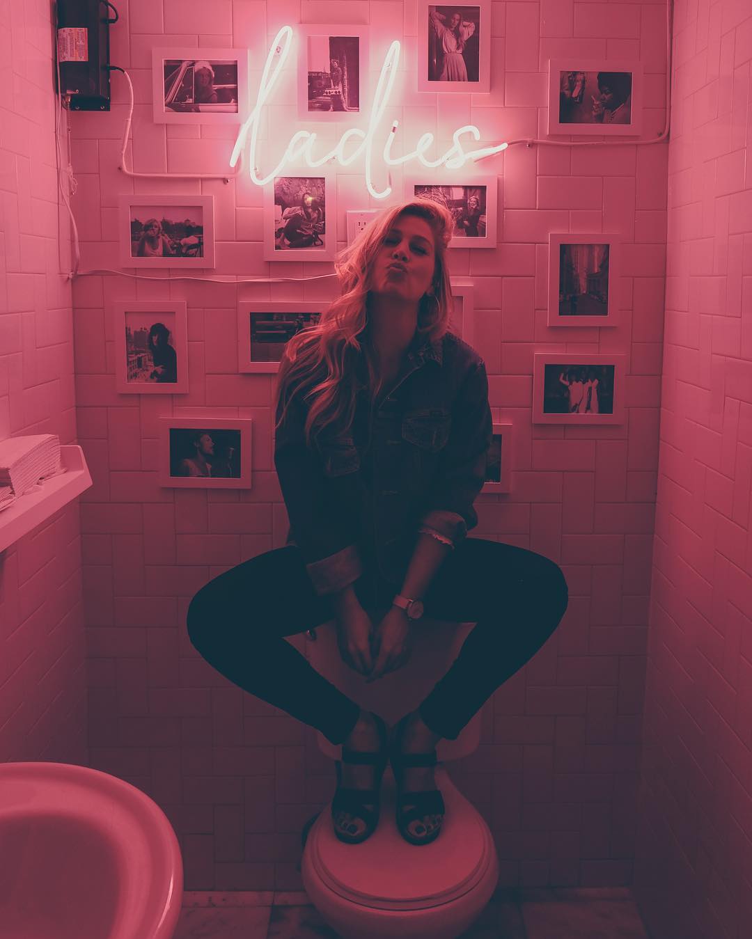ladies neon pink sign in bathroom