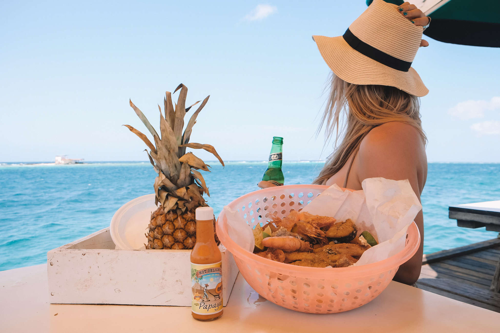 blonde drinking beer in aruba