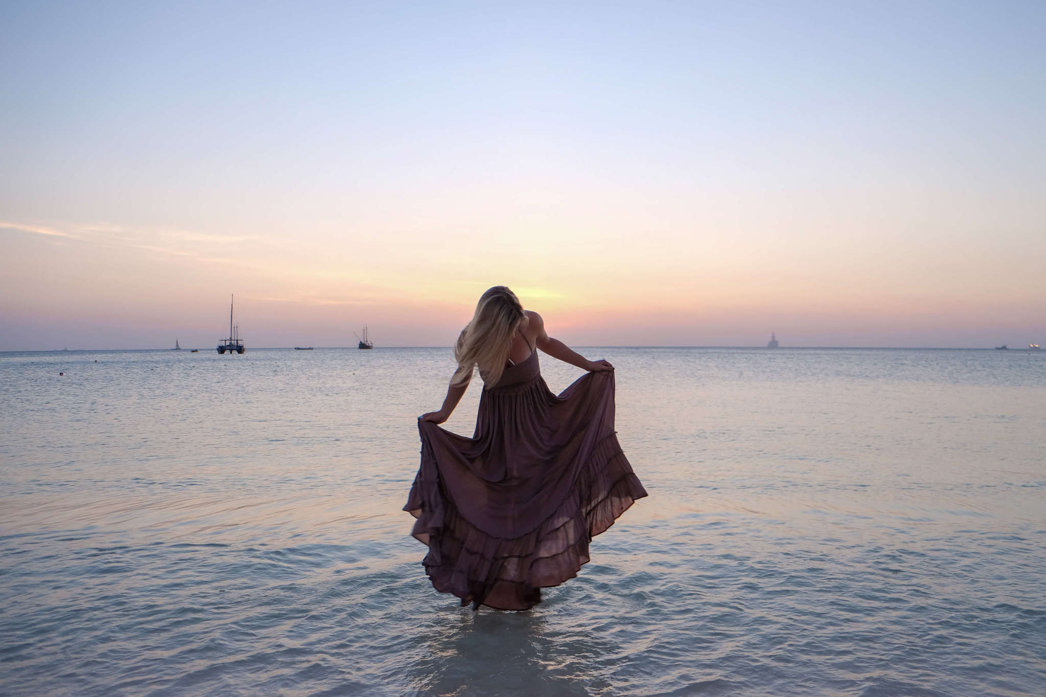 blonde in water sunset aruba