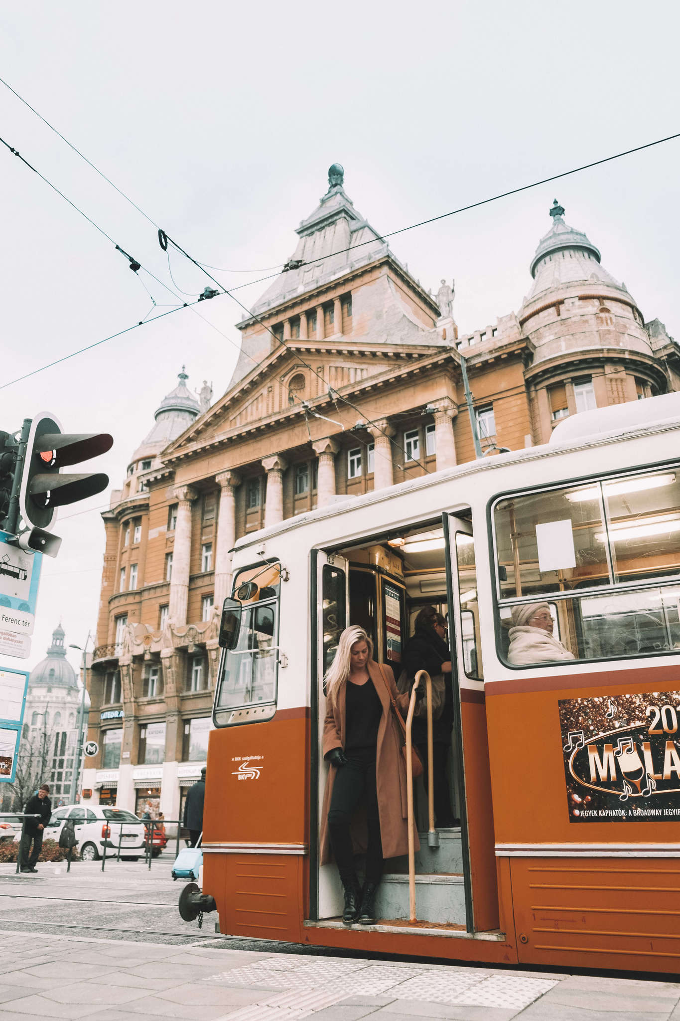 blonde getting of tram in Budapest